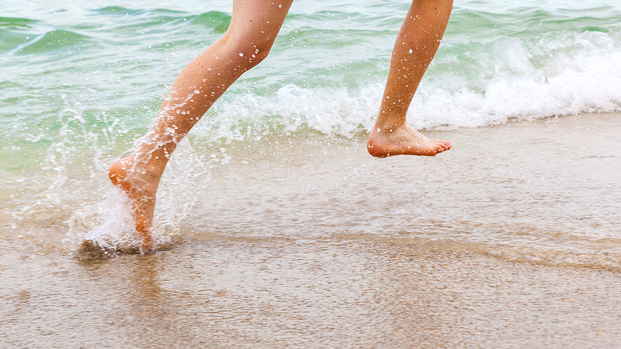 Feet running on beach