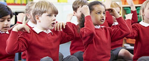 Schoolchildren singing heads, shoulders, knees and toes
